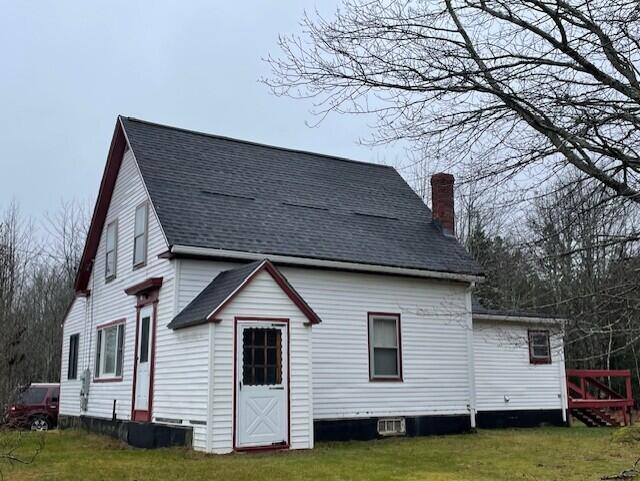 back of house with a lawn