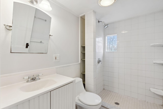 bathroom featuring tiled shower, vanity, and toilet