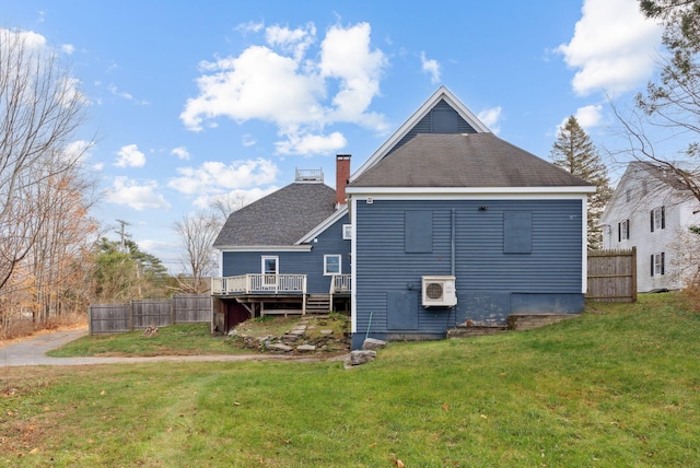 back of house featuring a lawn, a wooden deck, and ac unit