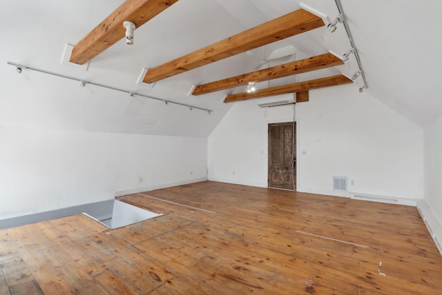 additional living space featuring hardwood / wood-style floors, vaulted ceiling with beams, and a wall mounted AC