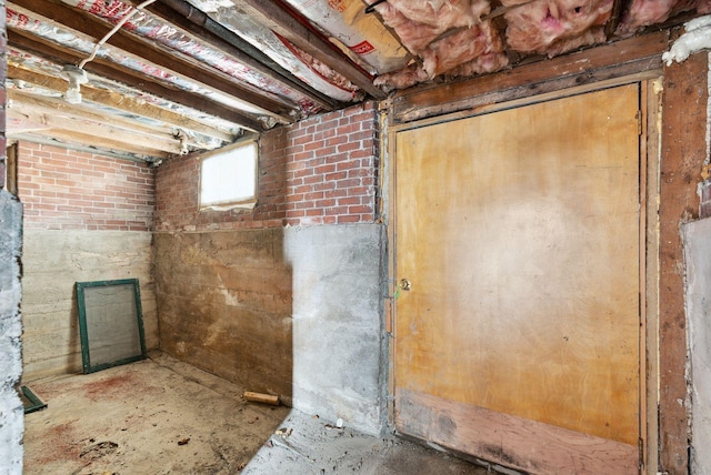 basement featuring brick wall