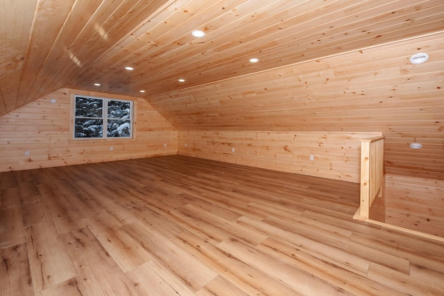 bonus room with wooden ceiling, light hardwood / wood-style flooring, wood walls, and vaulted ceiling