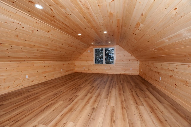 bonus room featuring vaulted ceiling, wooden walls, light hardwood / wood-style floors, and wooden ceiling