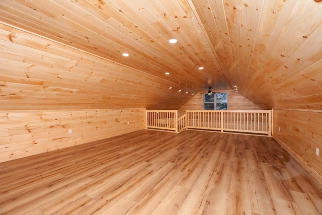 bonus room featuring wood walls, light hardwood / wood-style floors, and wood ceiling