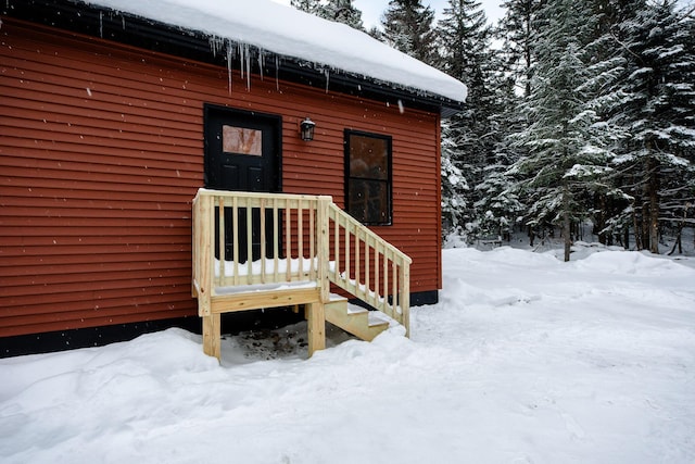 view of snow covered property entrance