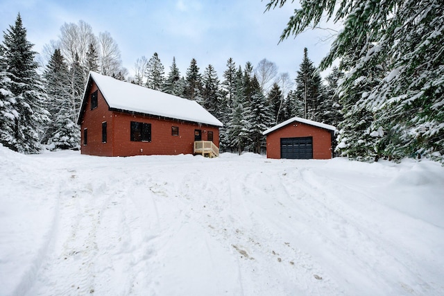 exterior space featuring a detached garage and an outdoor structure