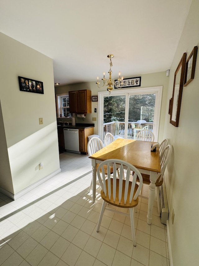 dining space featuring light tile patterned floors, baseboards, and a chandelier