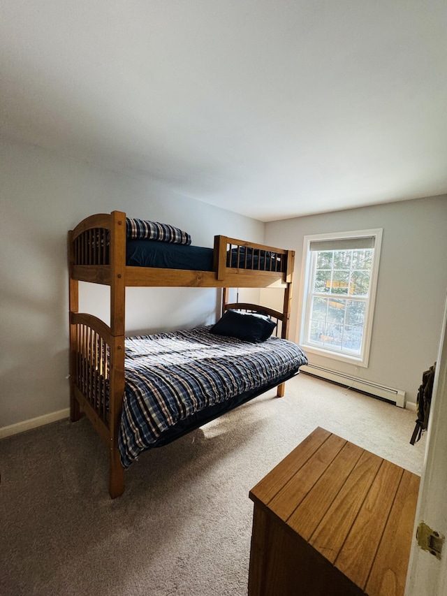 bedroom with a baseboard heating unit, carpet, and baseboards