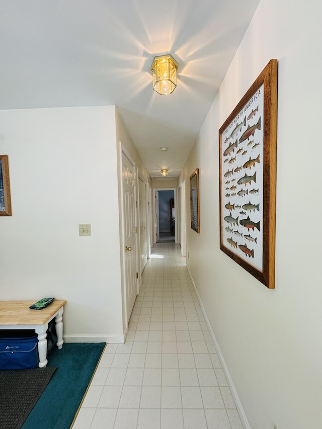 hall with light tile patterned floors and baseboards