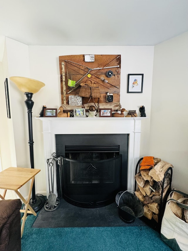 room details featuring a fireplace and carpet