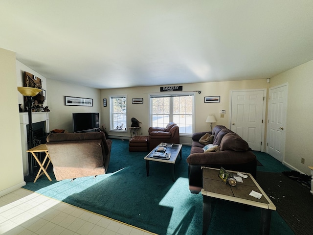 carpeted living room with baseboards and a fireplace