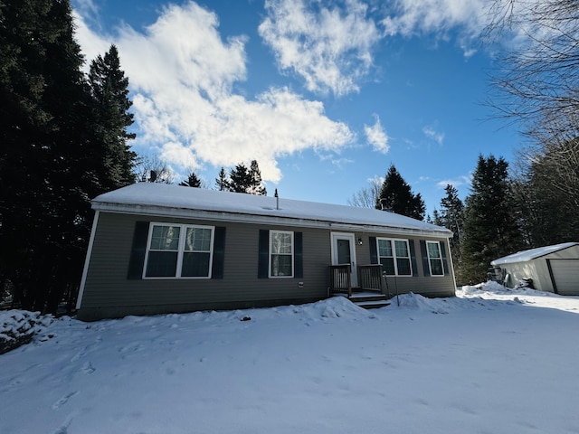 manufactured / mobile home with an outdoor structure and a detached garage