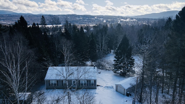 snowy aerial view featuring a mountain view