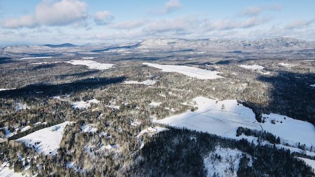 snowy aerial view with a mountain view