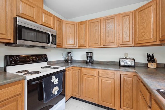 17 Saddleback Vw, Rangeley, ME 04970 - kitchen featuring stainless steel microwave, electric range oven, dark countertops, and light tile patterned floors