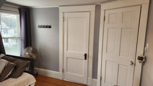 bedroom with hardwood / wood-style floors and ornamental molding