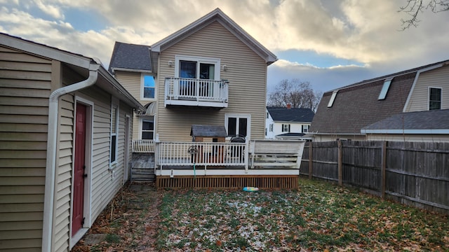 back of house featuring a wooden deck