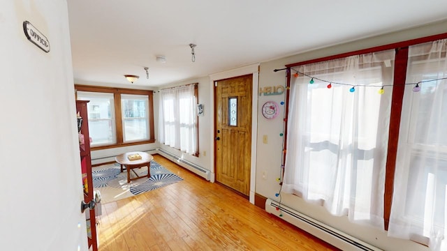 foyer entrance with light hardwood / wood-style flooring and a baseboard radiator