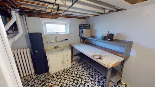 interior space featuring radiator heating unit and sink