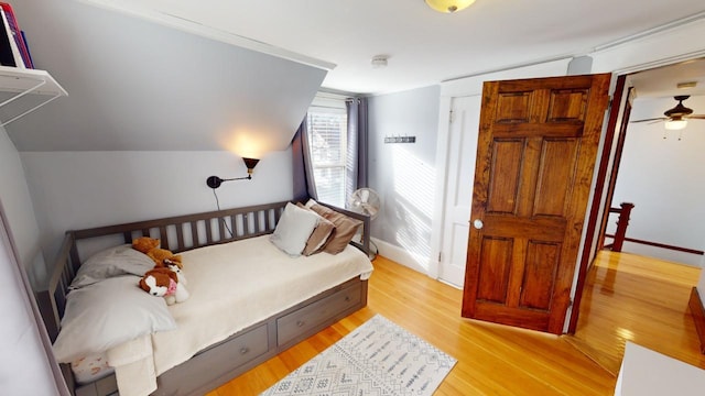 bedroom featuring vaulted ceiling and light hardwood / wood-style flooring