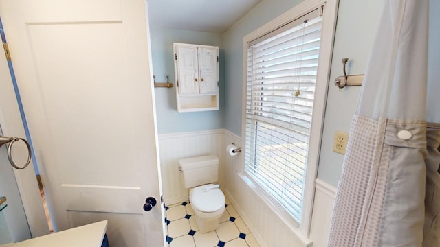 bathroom with tile patterned floors and toilet