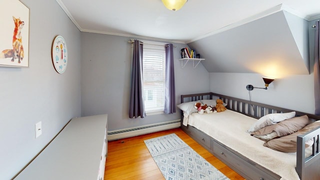 bedroom featuring ornamental molding, vaulted ceiling, light hardwood / wood-style flooring, and a baseboard heating unit