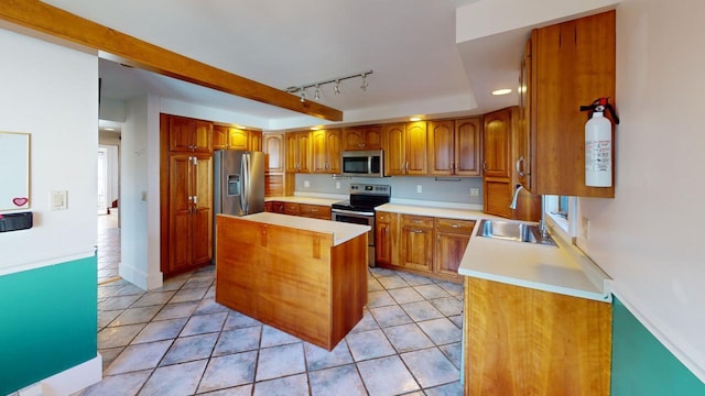 kitchen featuring a center island, track lighting, sink, light tile patterned floors, and appliances with stainless steel finishes