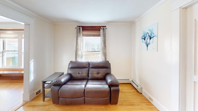 sitting room with light hardwood / wood-style floors, a baseboard radiator, and ornamental molding