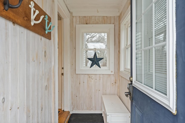 mudroom with wood walls