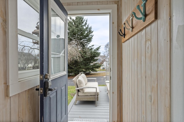 doorway featuring wood walls