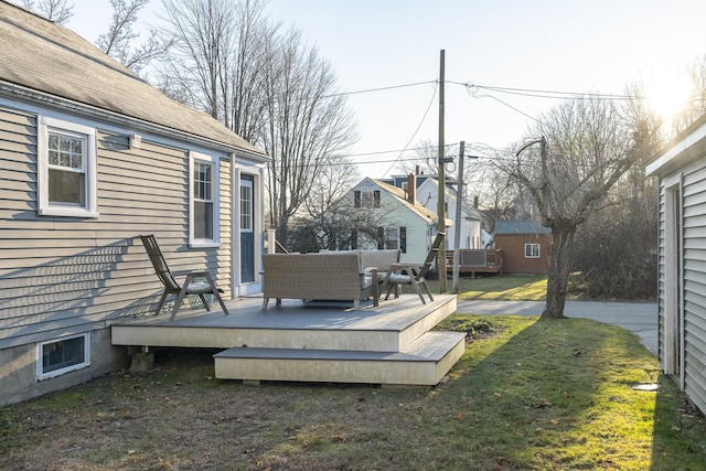 wooden deck featuring outdoor lounge area and a yard