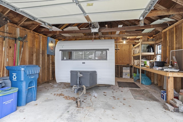 garage featuring wooden walls and a garage door opener