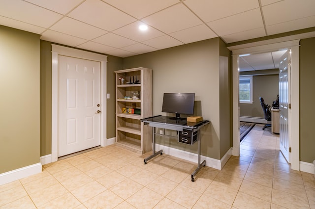 office featuring a paneled ceiling, light tile patterned floors, and a baseboard heating unit