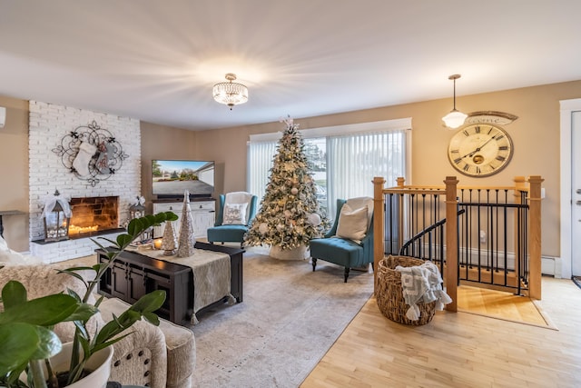 living room featuring a fireplace, a chandelier, and light wood-type flooring