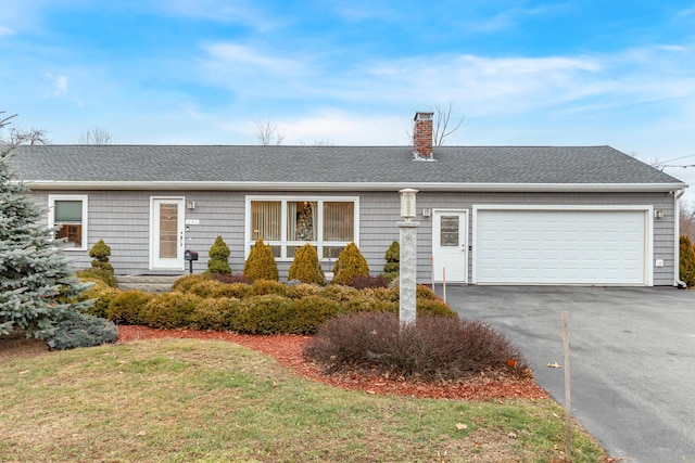 single story home with a garage and a front yard