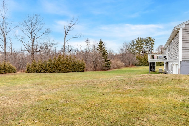 view of yard featuring cooling unit and a deck