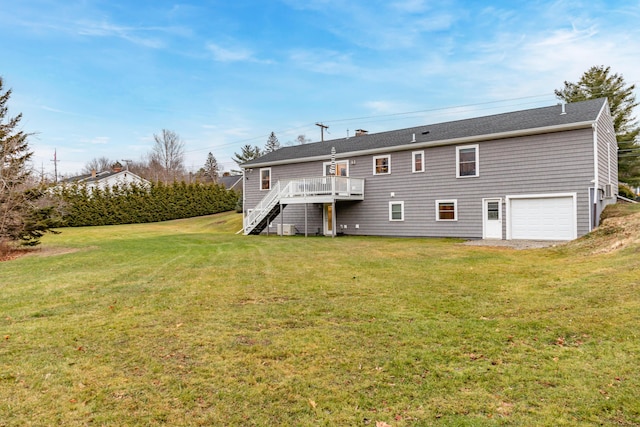 back of house with a yard, a garage, and a deck