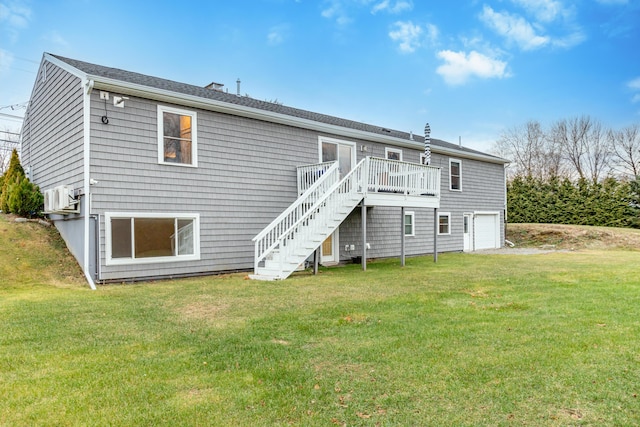 back of house featuring a garage, a deck, and a yard