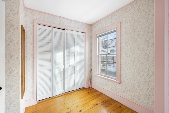 unfurnished bedroom featuring hardwood / wood-style floors and a closet