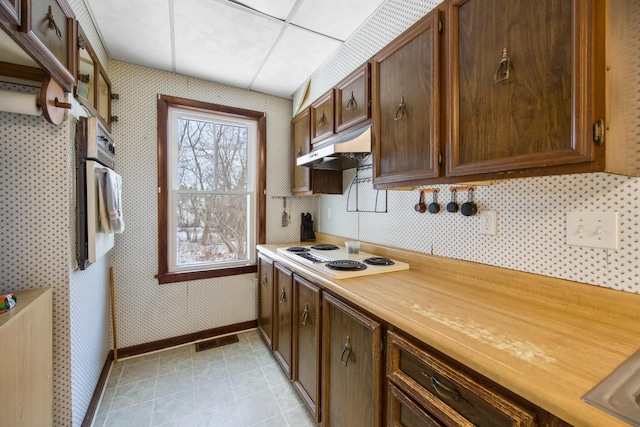 kitchen featuring white electric cooktop and oven