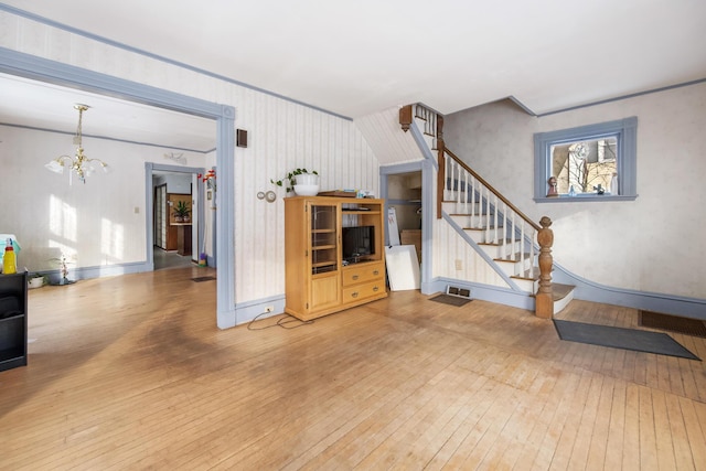 living room featuring hardwood / wood-style floors and a notable chandelier