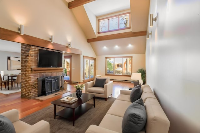 living room featuring a brick fireplace, hardwood / wood-style flooring, high vaulted ceiling, and beam ceiling