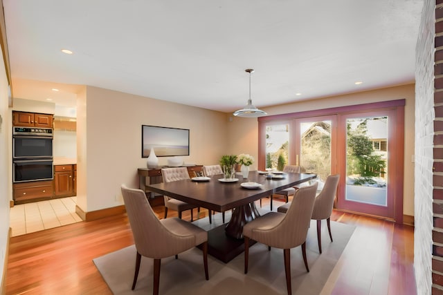 dining space featuring light wood-type flooring