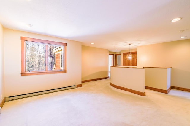 carpeted spare room with a baseboard radiator and a notable chandelier