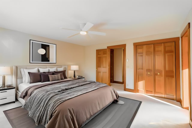 carpeted bedroom featuring a closet and ceiling fan