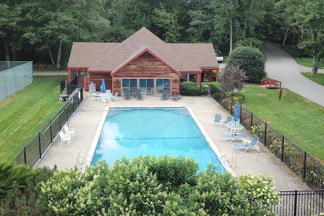 view of pool with a yard and a patio area