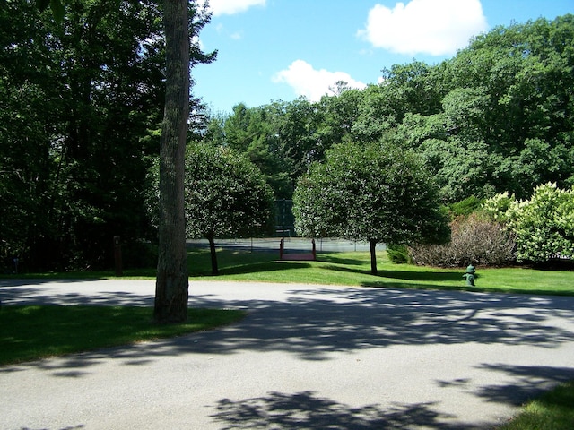 surrounding community featuring tennis court