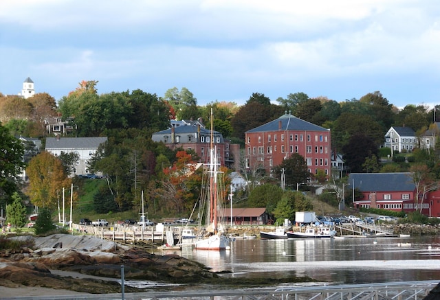 view of community featuring a water view and a dock