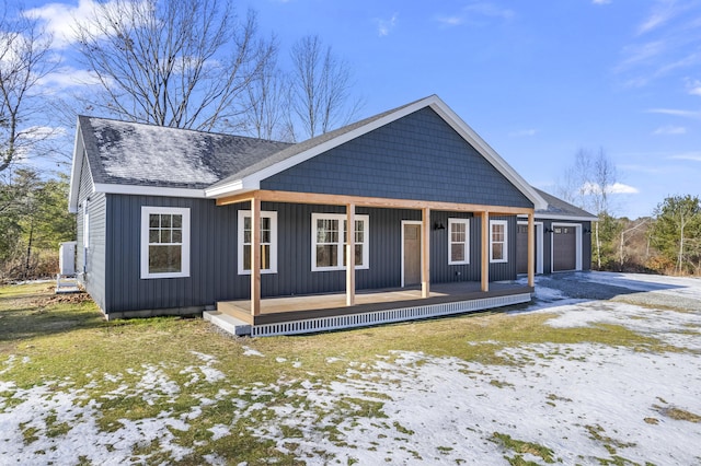 view of front of home with covered porch and a garage