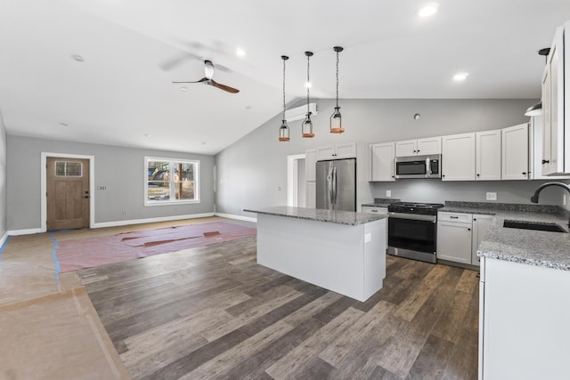 kitchen with white cabinets, a kitchen island, sink, and stainless steel appliances